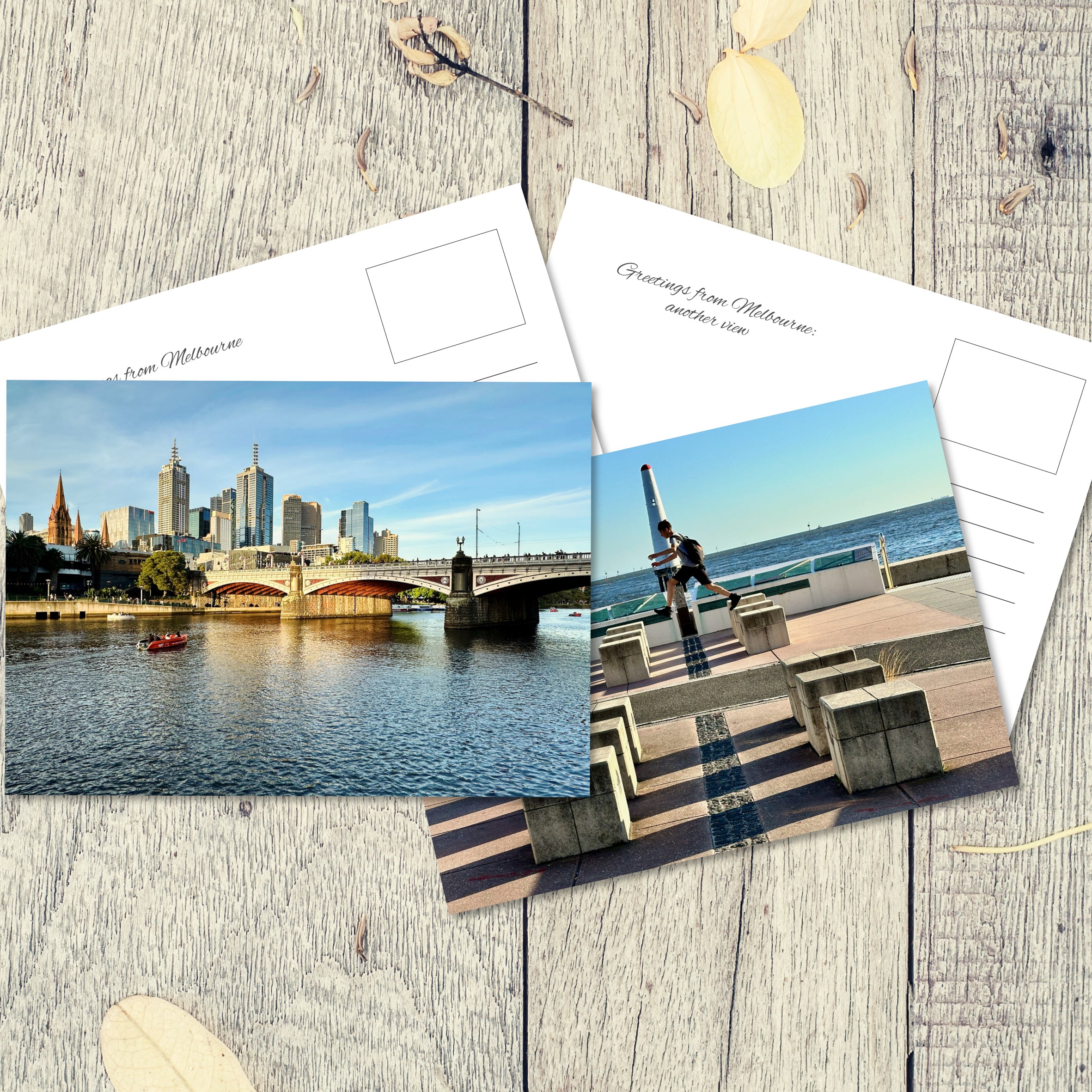 Postcards from Melbourne, one showing a bridge reflecting in the river at golden hour and another of a boy leaping over blocks