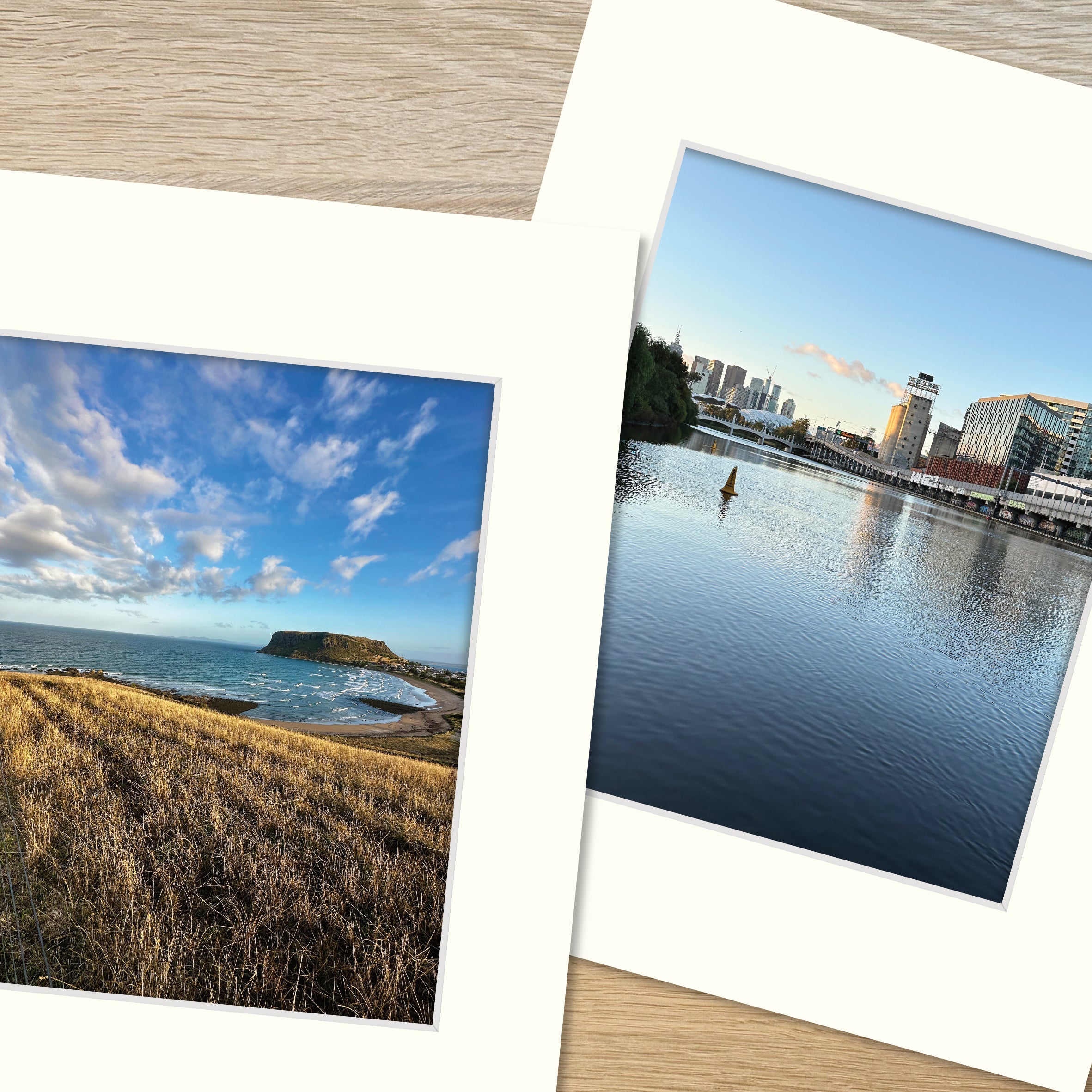 Two frame mounts, one containing a print of a spectacular coastline and another of serene reflections in a river