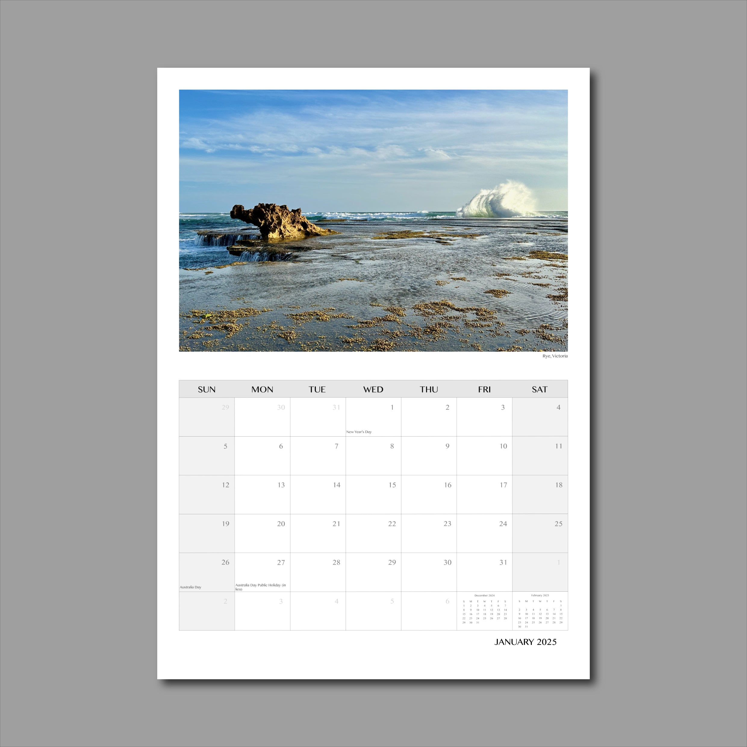 A3 Wall Calendar: Captivating Vistas featuring an ocean scene with a dragon-like rock formation and a large wave curling