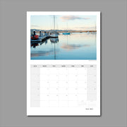 A3 Wall Calendar: Captivating Vistas featuring a very tranquil dusk scene of yachts reflecting in the water with hues of blues and pinks