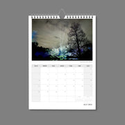 A4 Wall Calendar: Marvellous Melbourne featuring a night scene of park trees illuminated with hues of blues, greens and purples