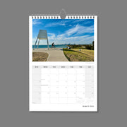 A4 Wall Calendar: Marvellous Melbourne featuring a monument and cyclist on a hill with backdrop of city skyline