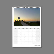 A4 Wall Calendar: Golden Hour featuring a small structure on top of hill with people clustering, all silhouetted against a sunset