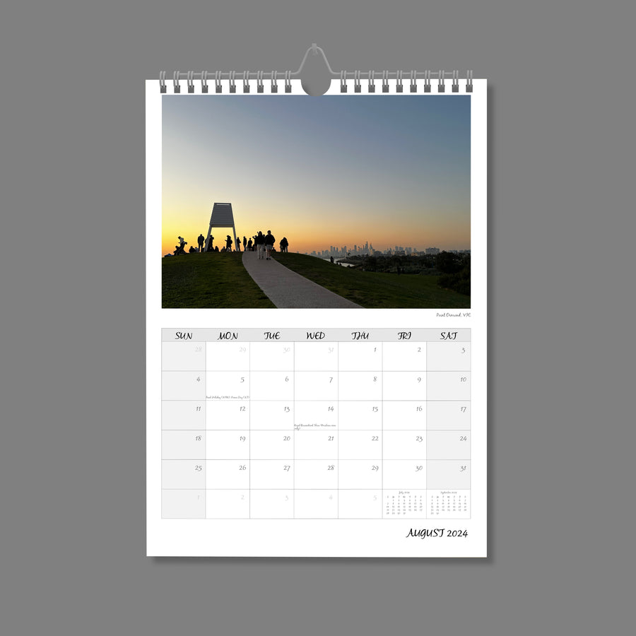 A4 Wall Calendar: Golden Hour featuring a small structure on top of hill with people clustering, all silhouetted against a sunset