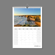 A4 Wall Calendar: Golden Hour featuring spectacular coastline with tall rock formations all sunlit jutting out of the sea at dusk