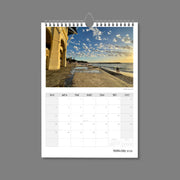 A4 Wall Calendar: Golden Hour featuring a peaceful beach scene at dusk with a building beautifully sun lit golden