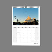 A4 Wall Calendar: Golden Hour featuring the sails of the Sydney Opera House tipped in golden light with seagulls flying near