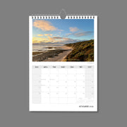 A4 Wall Calendar: Golden Hour featuring greens and browns of coastal scrub sunlit next to the ocean and a pretty sky