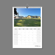 A4 Wall Calendar: Golden Hour featuring a collection of old houses sunlit on green grass