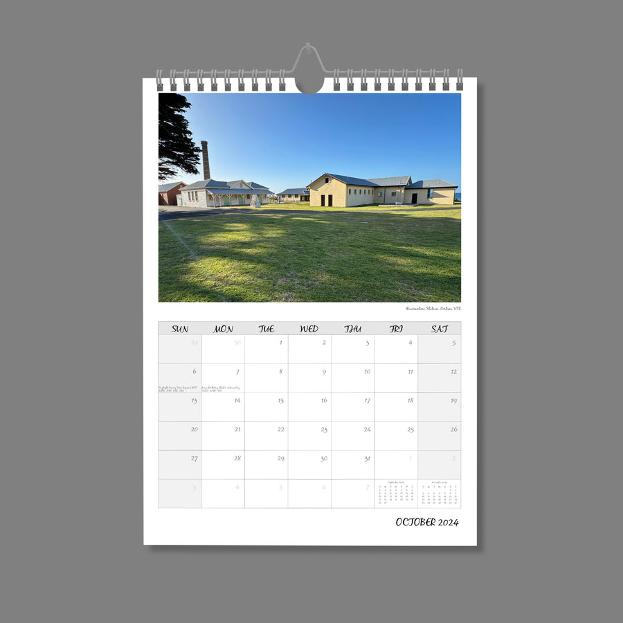 A4 Wall Calendar: Golden Hour featuring a collection of old houses sunlit on green grass