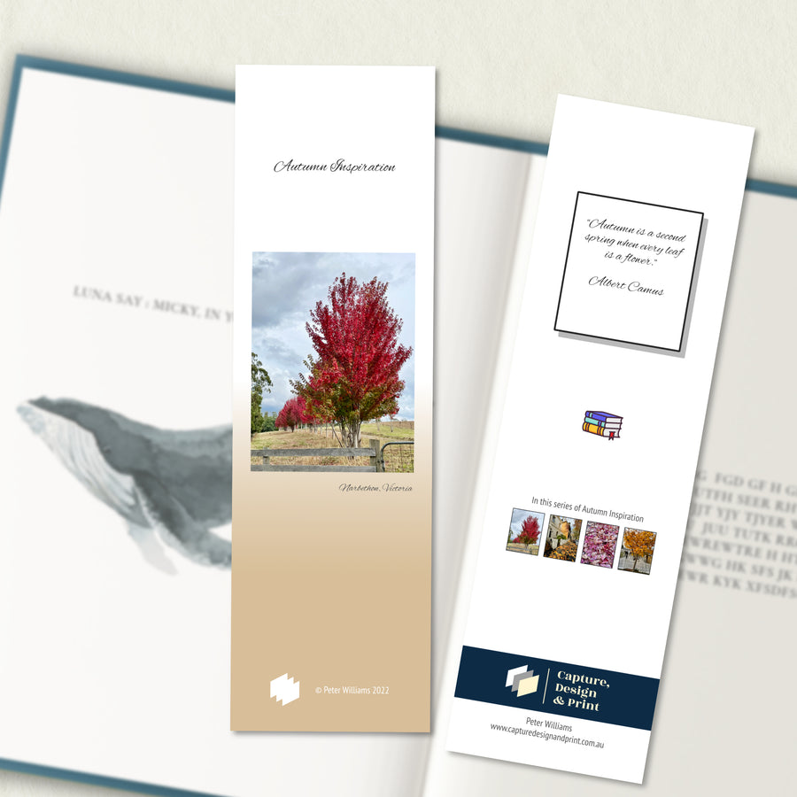 A two sided 200 x 60 bookmark displayed inside a book, featuring Red Maple trees in a field with deep red autumn foliage