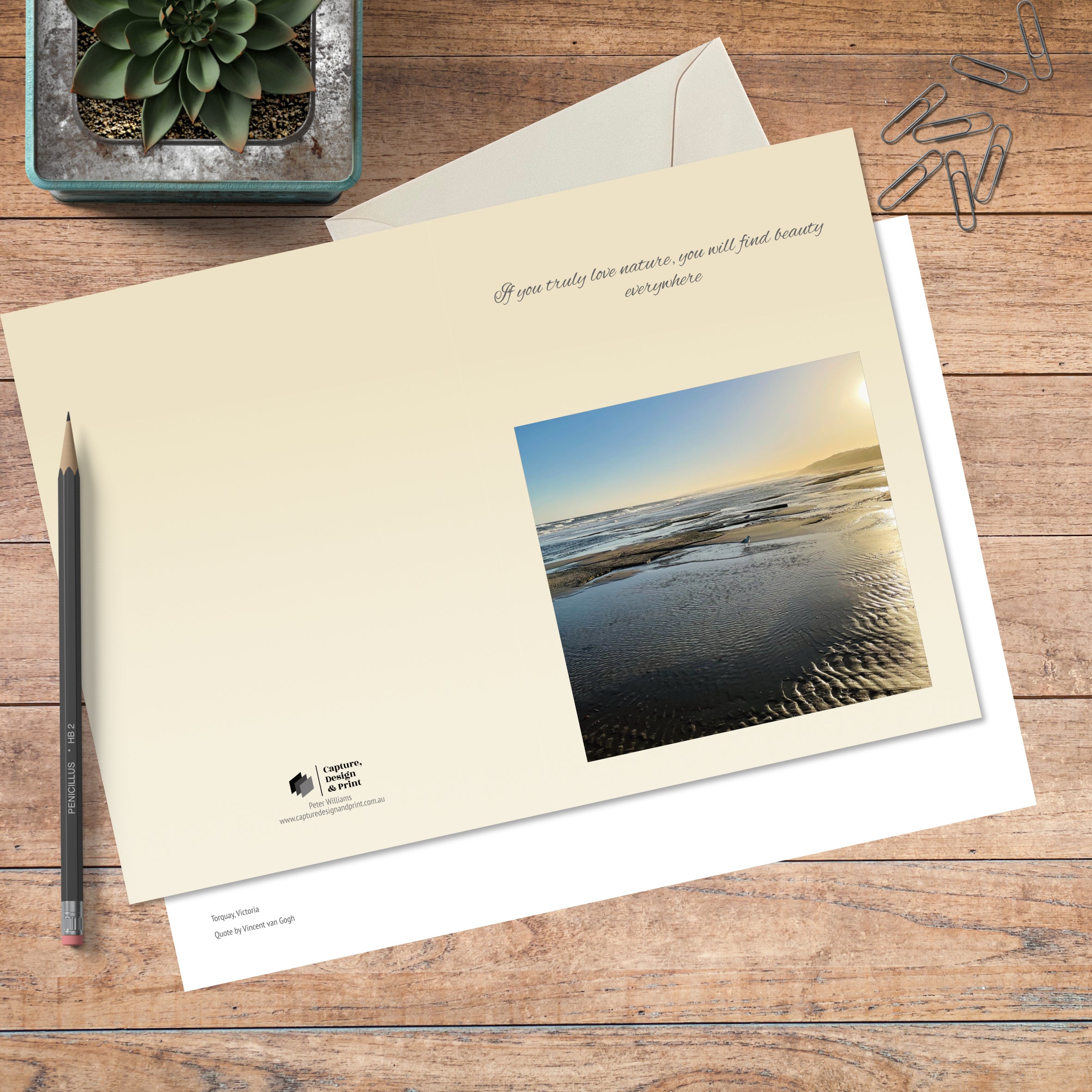 A6 greeting card in colour with full spread displayed on timber, featuring a tidal scene at dusk and a nature quote