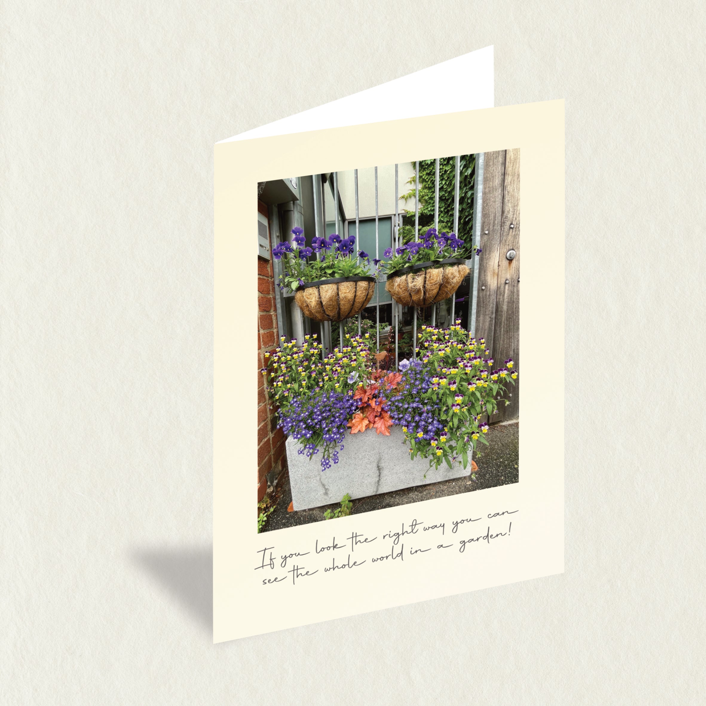 Designer Greeting Card: Spring Garden features a cheerful garden of overflowing flowers in a planter box and hanging baskets