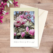 A6 greeting card of the beautiful pink and white colours of the cup-like Magnolia flowers in flat-lay with envelope 