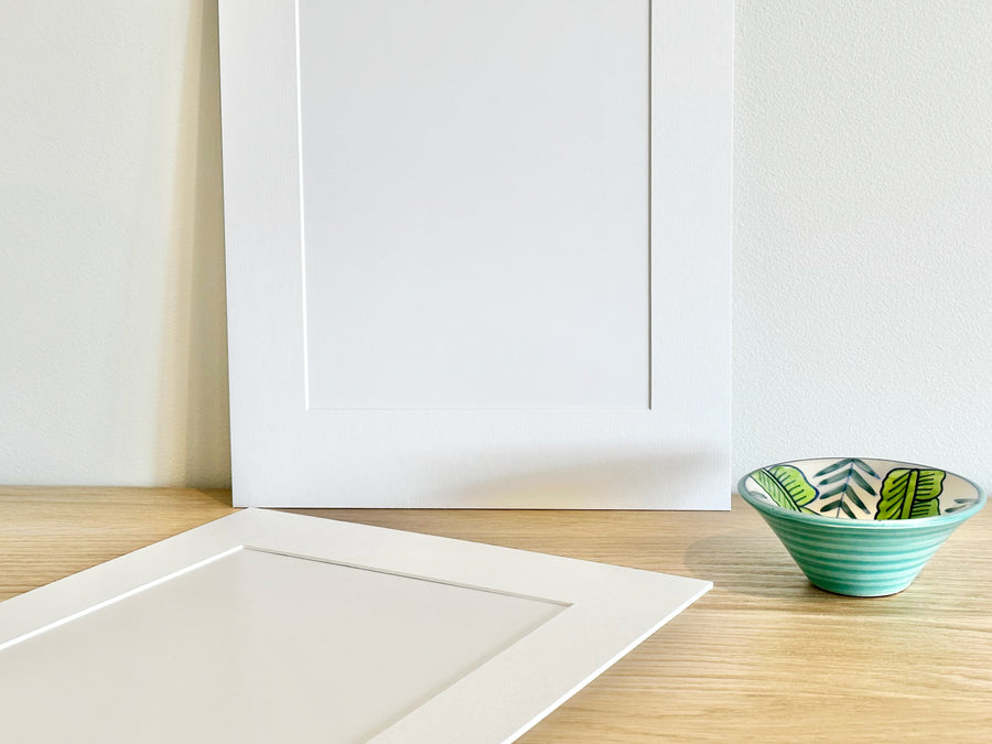 Two frame mounts on sideboard before Autumn Bright print is inserted.