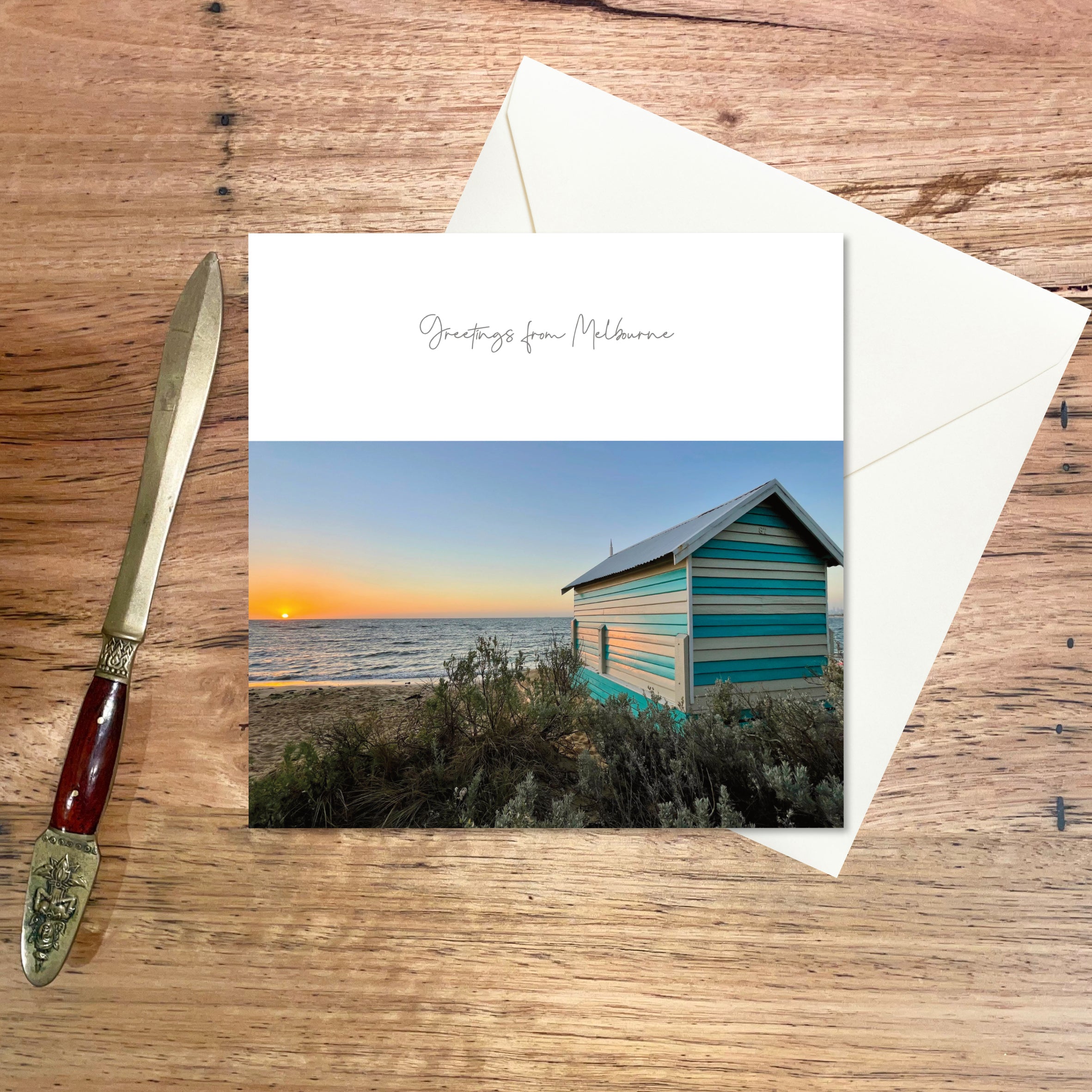 Greeting Card Melbourne: Bathing Box featuring a solitary box on the popular beach looking westward at sunset across the bay