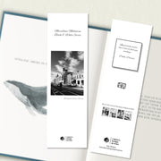 A two sided 200 x 60 bookmark displayed inside a book, featuring an urban street in classic B&W with white background variant