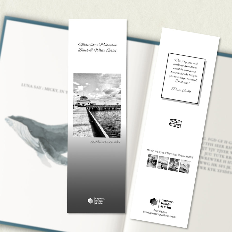 A two sided 200 x 60 bookmark in B&W displayed inside a book, featuring the historic pier in the Bay with grey background variant