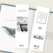 A two sided 200 x 60 bookmark in B&W displayed inside a book, featuring the historic pier in the Bay with white background variant