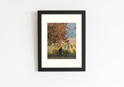 Frame mount with print of a rider surrounded by autumn foliage in finalised picture frame hanging on wall