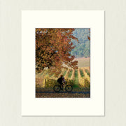 Ready to Frame Print: Autumn Feathertop - a frame mount containing a photo of a rider travelling on a path surrounded by autumn colour