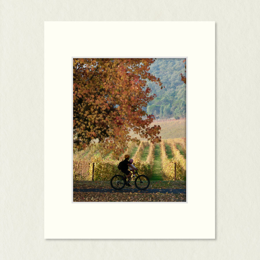 Ready to Frame Print: Autumn Feathertop - a frame mount containing a photo of a rider travelling on a path surrounded by autumn colour