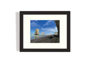 Frame mount with print of lofty rock formations jutting out of the ocean in finalised picture frame hanging on wall