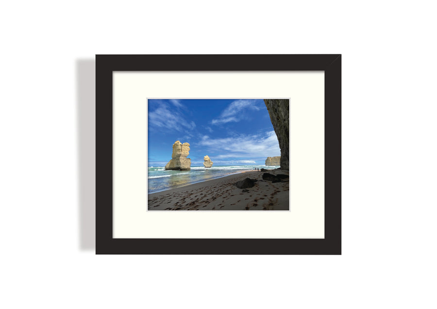 Frame mount with print of lofty rock formations jutting out of the ocean in finalised picture frame hanging on wall