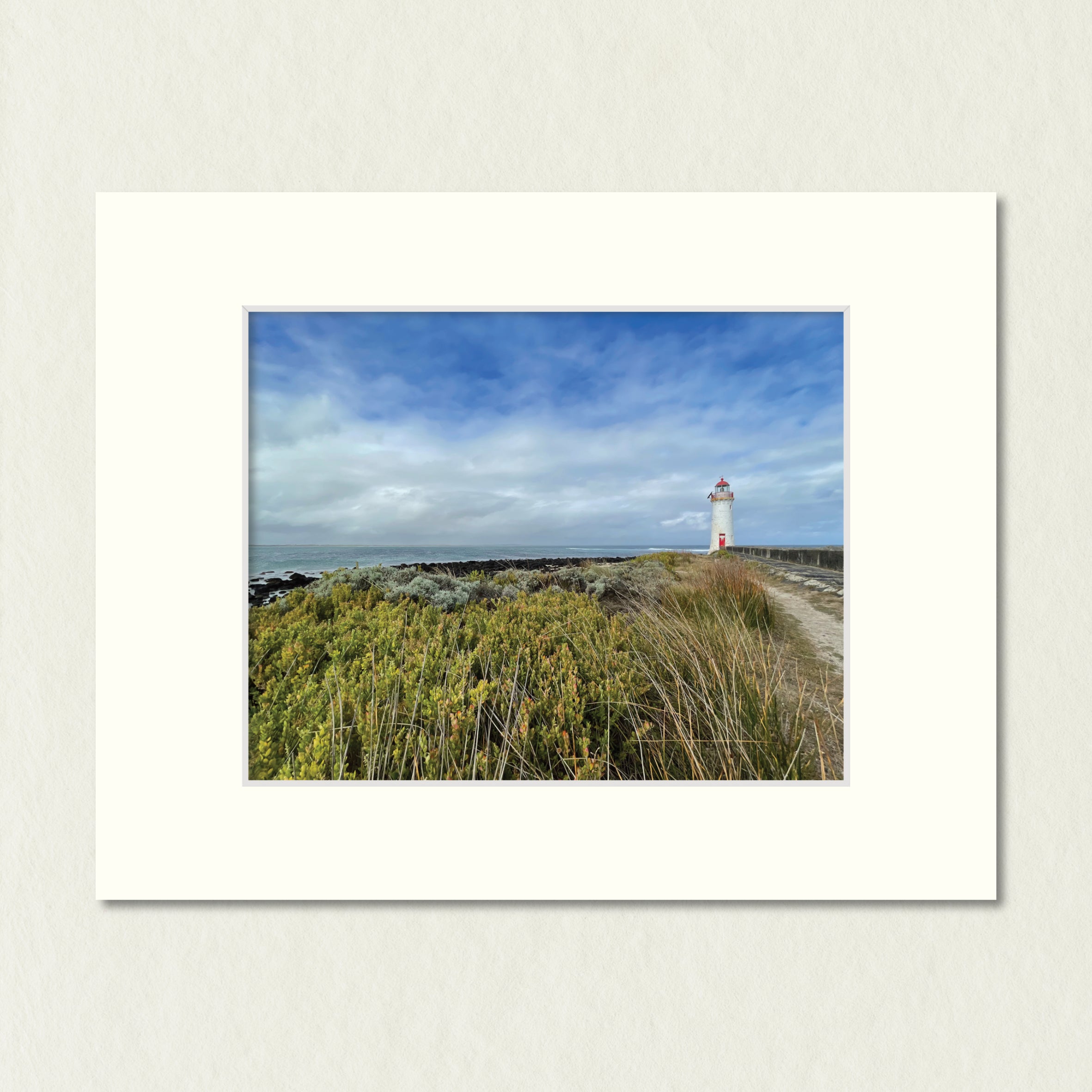 Ready to Frame Print: Griffiths Island Lighthouse - a frame mount containing a photo of a lighthouse with grassland and a stormy sky