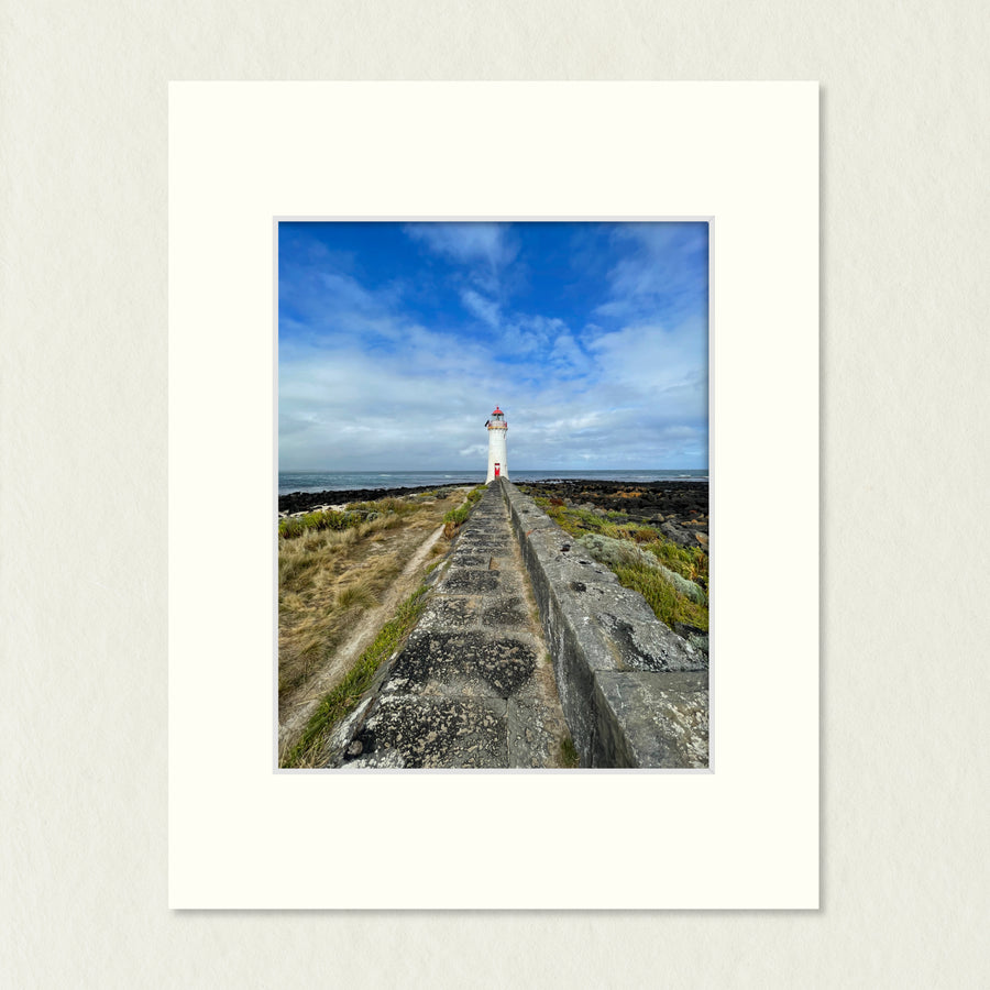 Ready to Frame Print: Griffiths Island Lighthouse - a frame mount containing a photo of a lighthouse at the end of a bluestone path