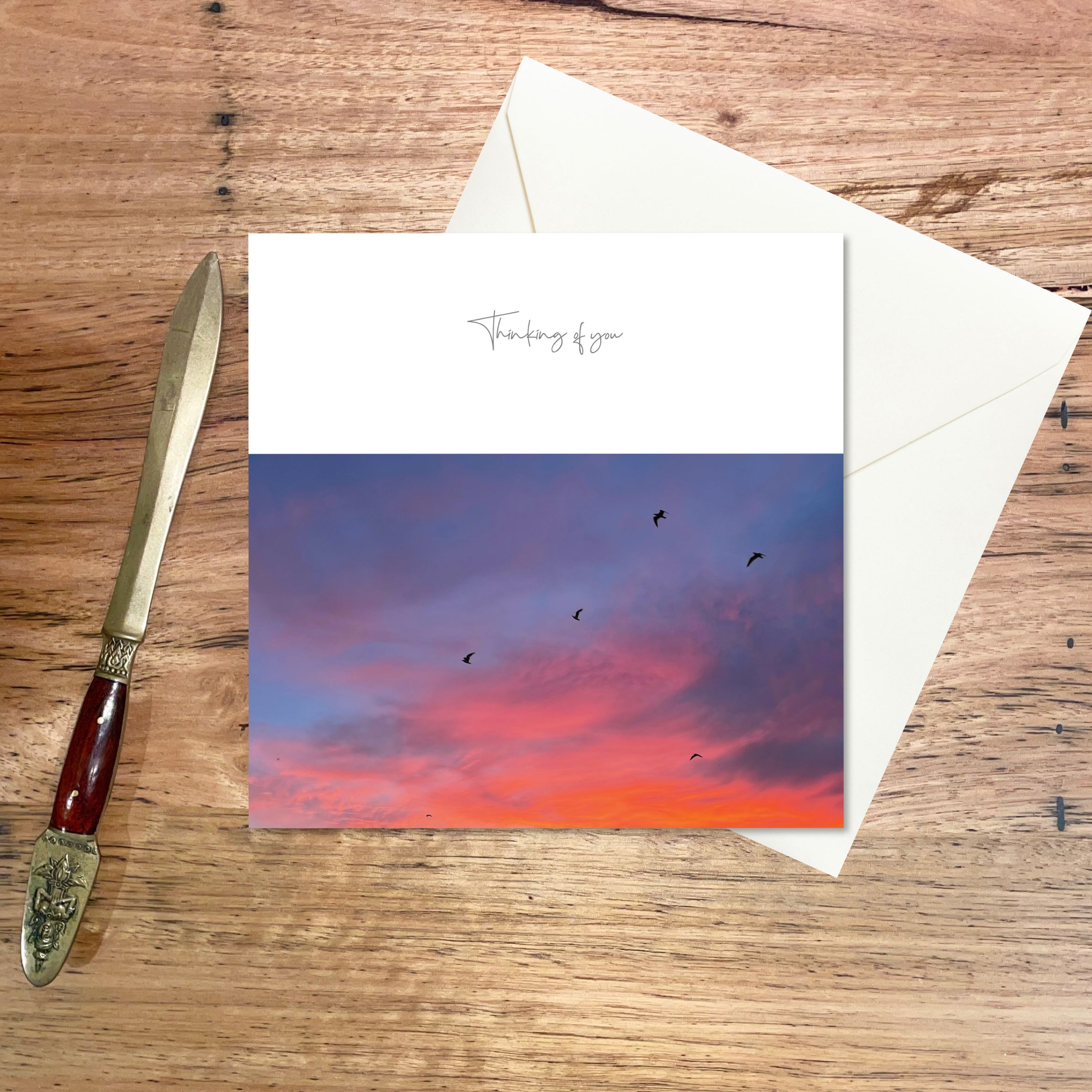 Thinking of You Card - Sunset Sky, a small square greeting card featuring birds silhouetted against a sunset sky of pinks & oranges